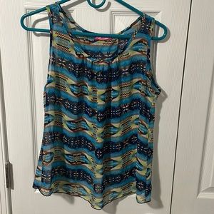 Very flowing lite top. Partially open back multicolored mostly blue